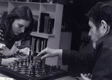 Joan La Barbara and John Cage playing chess before a rehearsal at his loft.